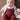 Conjunto Mayoral Newborn composto por body branco, casaco de malha jacquard e jardineiras bordeaux.