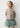 Cardigan de malha bege Mayoral para menina com flores brancas e folhas verdes.