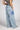 Calças de ganga Silvina Campos wide leg com flor estampada.