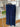 Modelo a usar calça fluida da marca Scusi em ambiente exterior elegante.