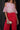 Túnica feminina Silvina Campos com estampado floral vermelho, ombros descobertos e decote com laço.